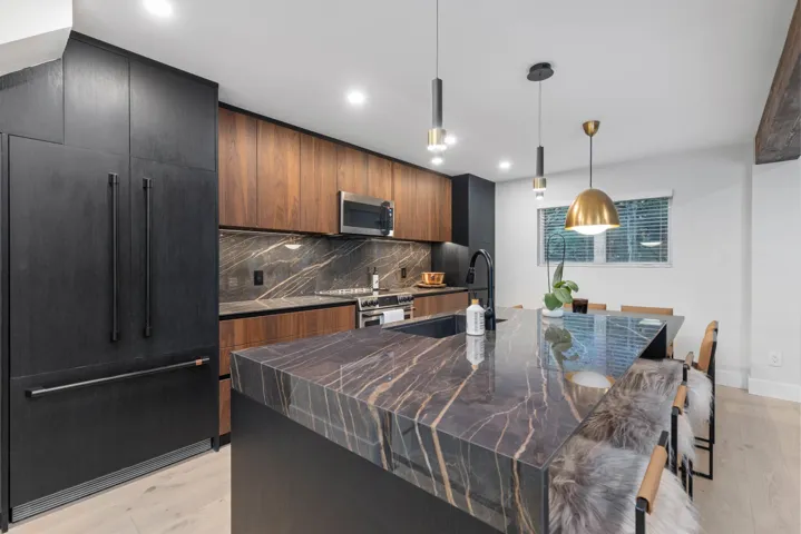 Kitchen with backsplash, modern cabinets, light wood-style floors, hanging light fixtures, and recessed lighting