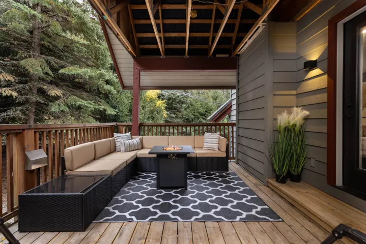 Wooden deck with an outdoor living space with a fire pit
