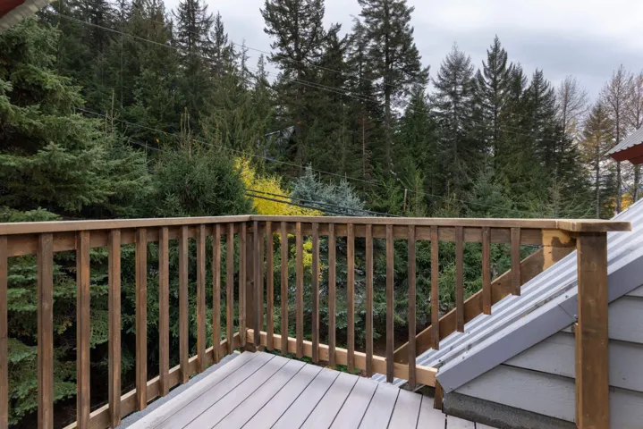Wooden terrace featuring view of scattered trees