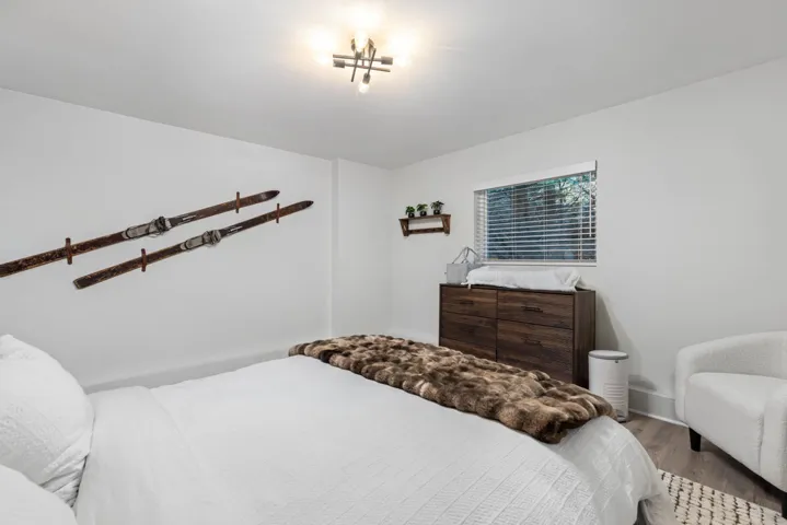 Bedroom featuring wood finished floors and baseboards