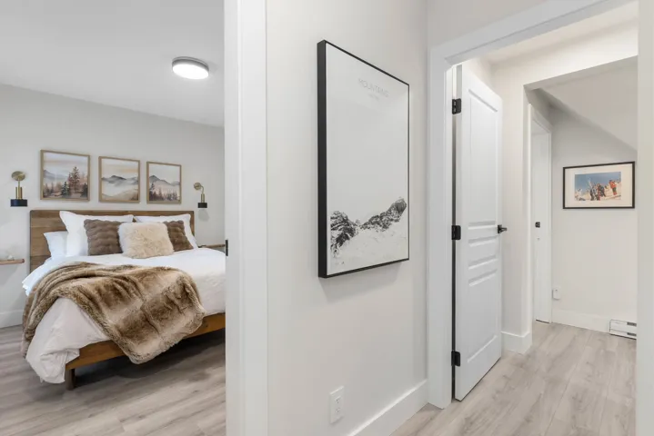 Bedroom with light wood-style flooring and a baseboard radiator