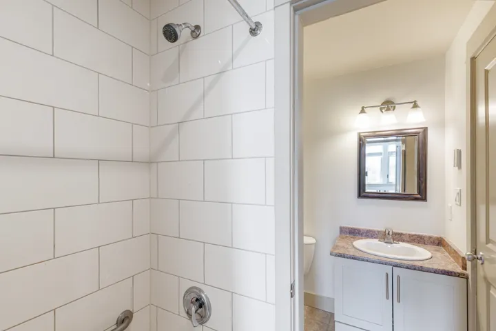 Contemporary bathroom featuring a subway-tiled shower with chrome fixtures
