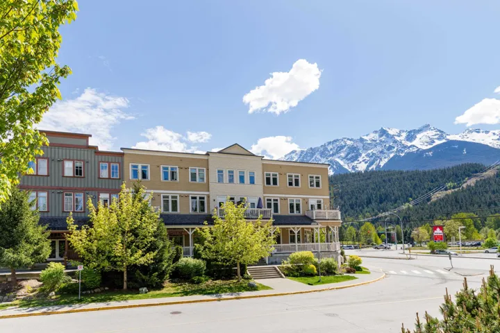 Multi-story building featuring varied facade treatments, multiple windows, and balconies