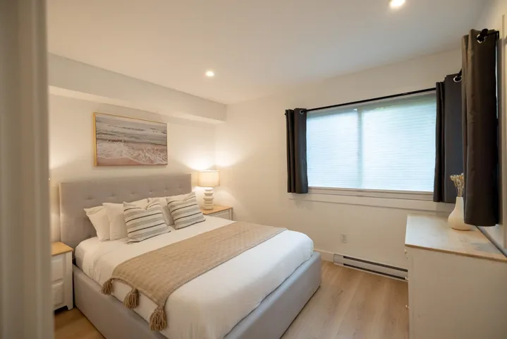 Bedroom featuring light wood-finish flooring, recessed lighting, and a window with blinds