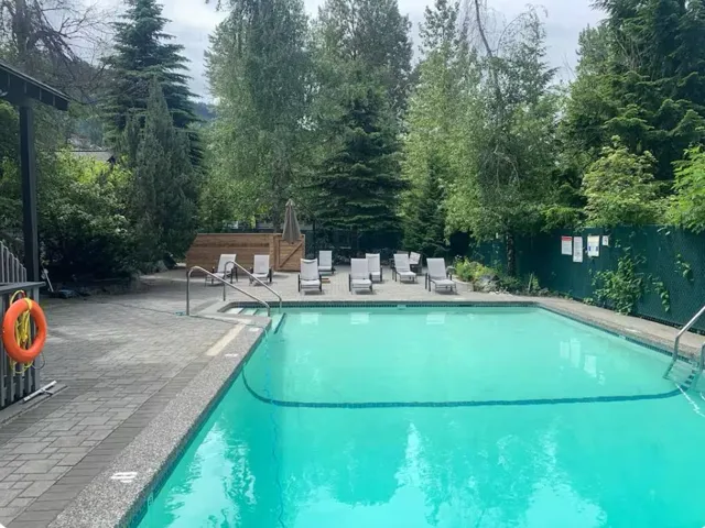 Outdoor swimming pool featuring integrated steps and handrails