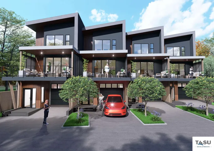Contemporary townhome exterior featuring an angular roofline, dark panel siding, private balconies with black railings, individual garage doors, and a wood-finish fence