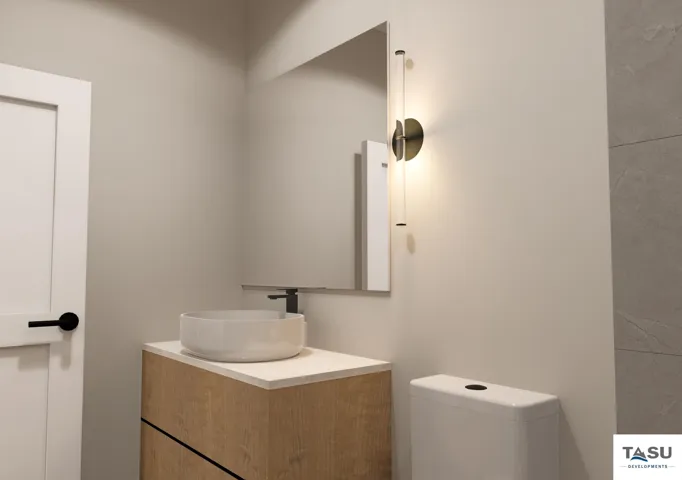 Modern powder room featuring a wood-finish vanity with a white vessel sink, matte black faucet, and rectangular mirror