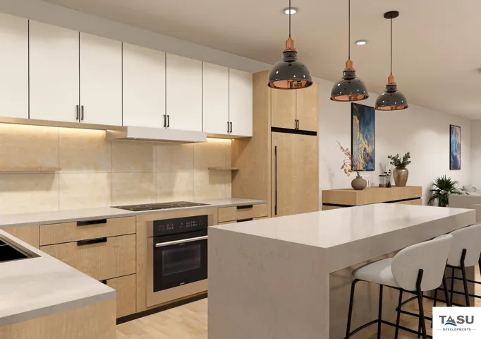 Modern kitchen featuring light wood-finish cabinetry, white upper cabinets, light stone countertops, built-in cooktop, and a matching built-in oven