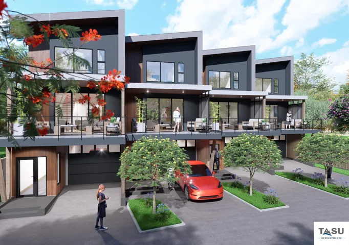 Modern townhouse exterior featuring a flat roofline, dark gray siding, and expansive balconies with black railings
