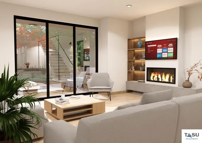 Spacious living area featuring full-height sliding glass doors, a contemporary fireplace, built-in shelving with integrated lighting, wood-finish flooring, and recessed ceiling lights