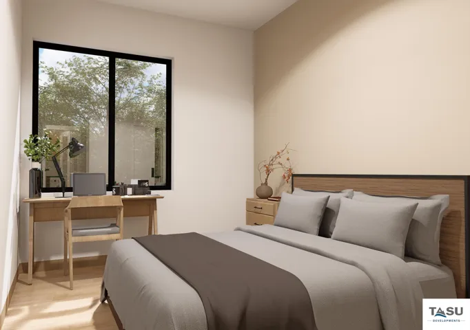 Light-toned walls complement wood-finish flooring in this room featuring a large window with black framing, a built-in wood-paneled headboard, and integrated bedside tables