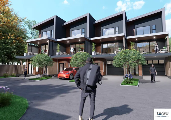 Modern townhome development featuring dark grey siding, wood-finish accents, and multiple private balconies with black railings