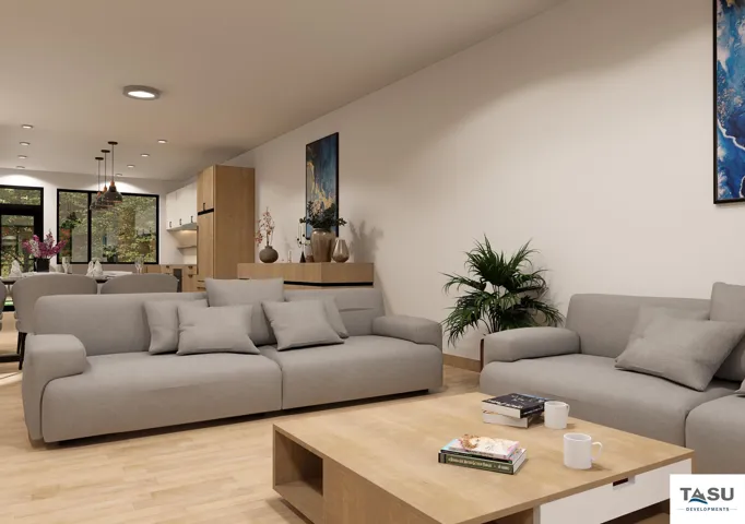 Open-concept living area with light wood-finish flooring, recessed ceiling lighting, and a neutral color palette