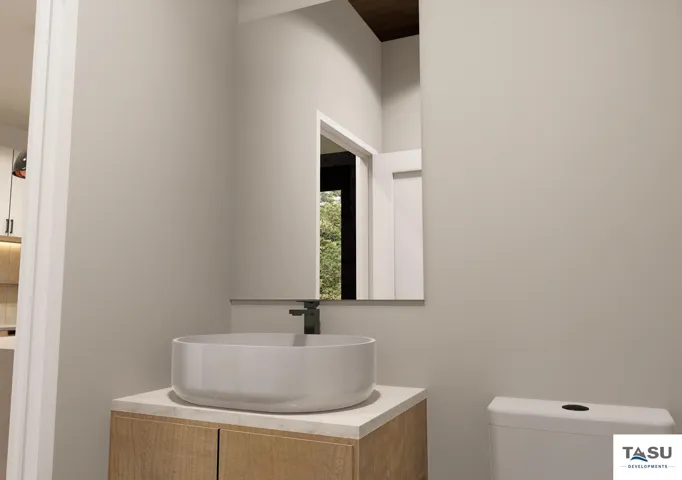 Modern vanity featuring a vessel sink with a wall-mounted faucet, wood-finish cabinetry, and light-toned countertop