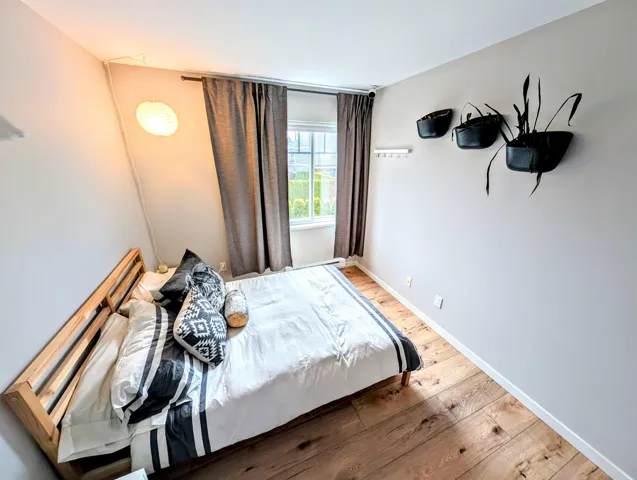Bedroom with baseboards and wood finished floors