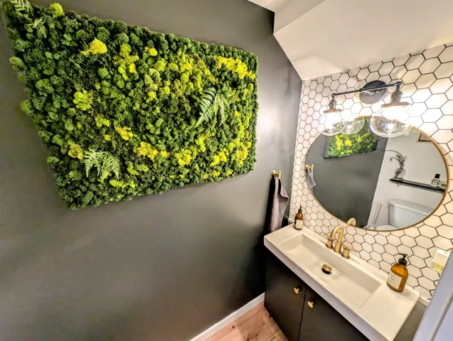 Bathroom featuring toilet, vanity, and baseboards