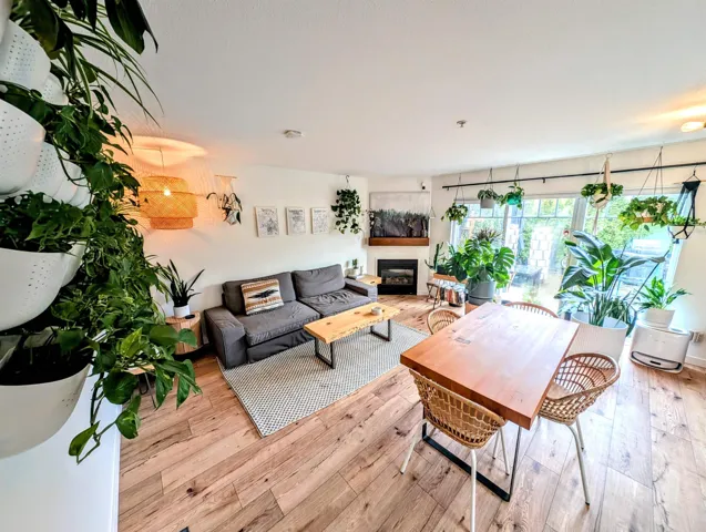 Living room featuring a glass covered fireplace and wood-type flooring