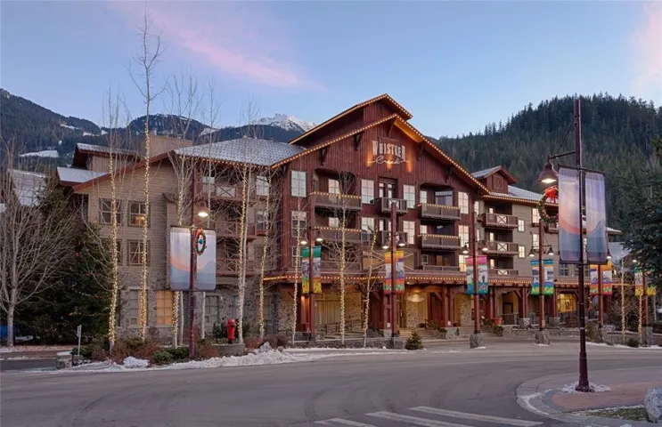 Property at dusk featuring a mountain view