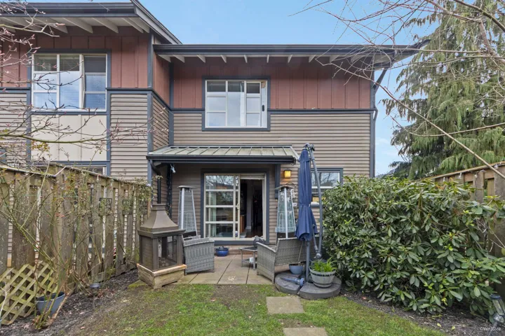Back of property with a patio, an outdoor living space, board and batten siding, and fence