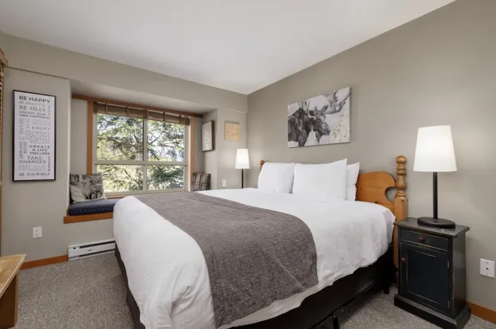 Carpeted bedroom featuring baseboard heating and baseboards