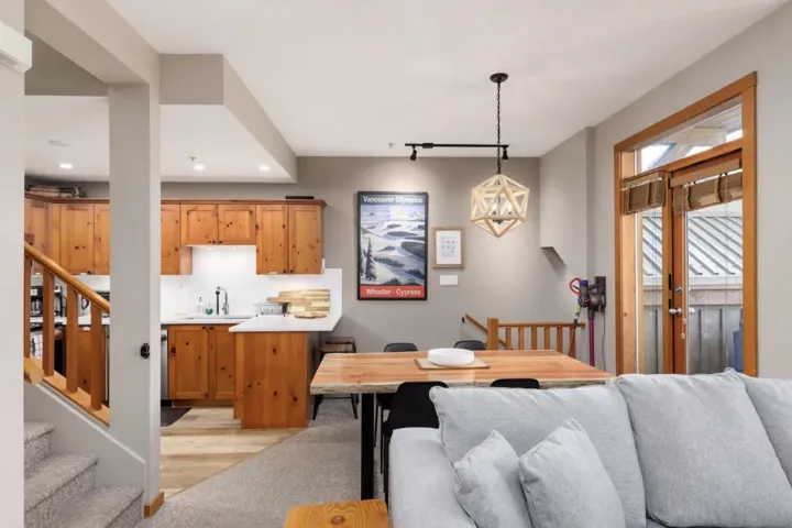 Dining room with stairway, rail lighting, and light wood-type flooring