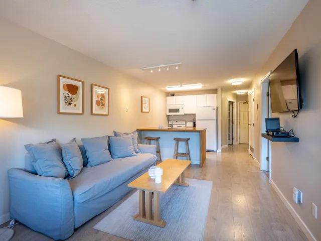 Living room with light wood-style flooring and baseboards