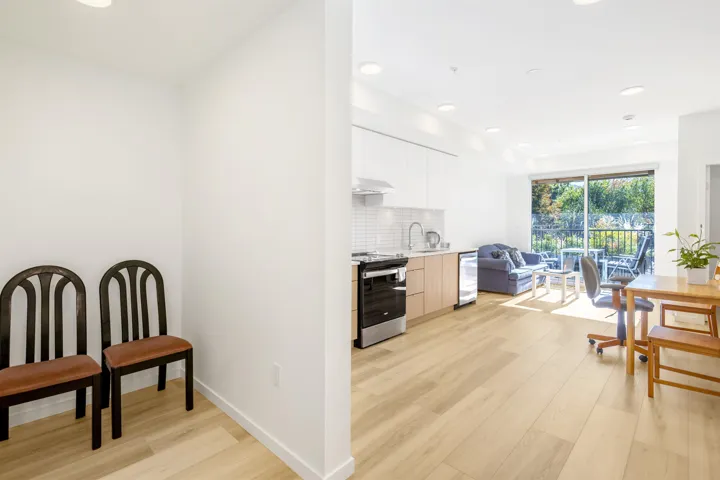 Kitchen featuring recessed lighting, light wood-style floors, modern cabinets, tasteful backsplash, and stainless steel appliances