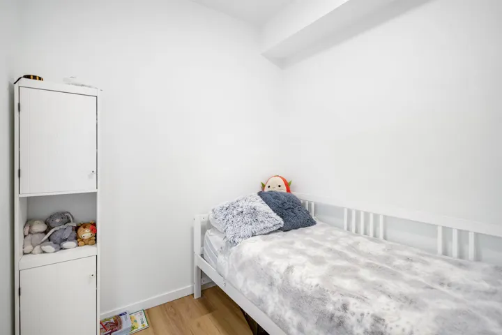 Bedroom with light wood-style floors and baseboards