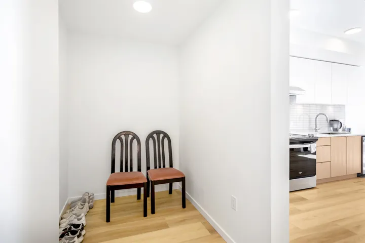 Living area with light wood-style floors and recessed lighting