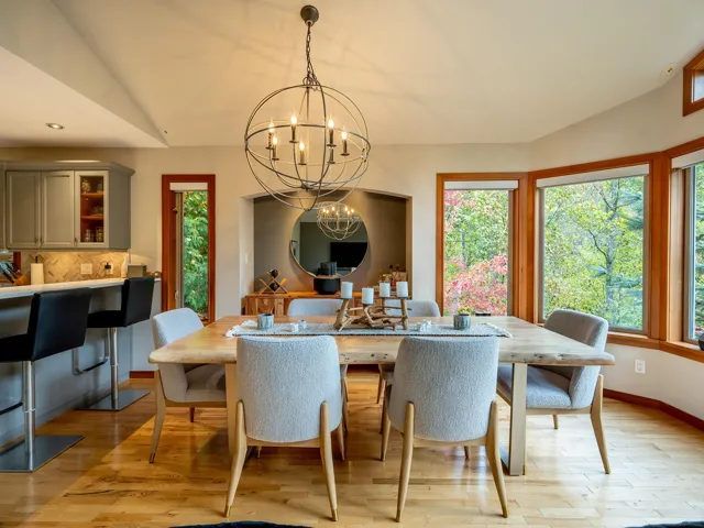 Dining space featuring light wood-style flooring, lofted ceiling, a chandelier, and recessed lighting