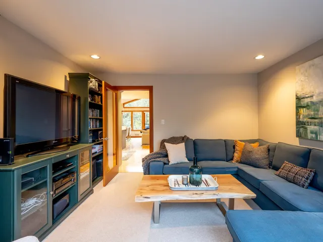 Living area with recessed lighting and light colored carpet