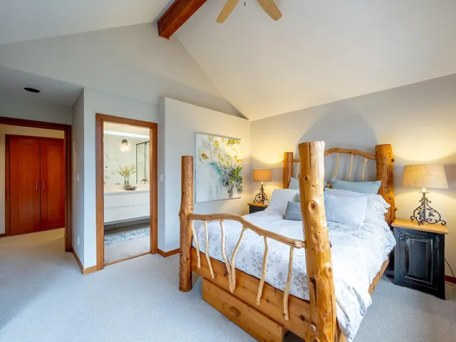 Bedroom featuring light carpet and ceiling fan