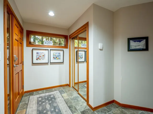 Corridor featuring stone finish flooring and recessed lighting