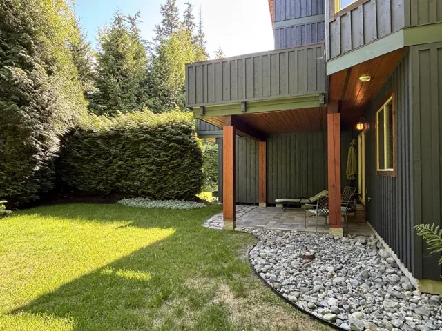 View of green lawn featuring a patio