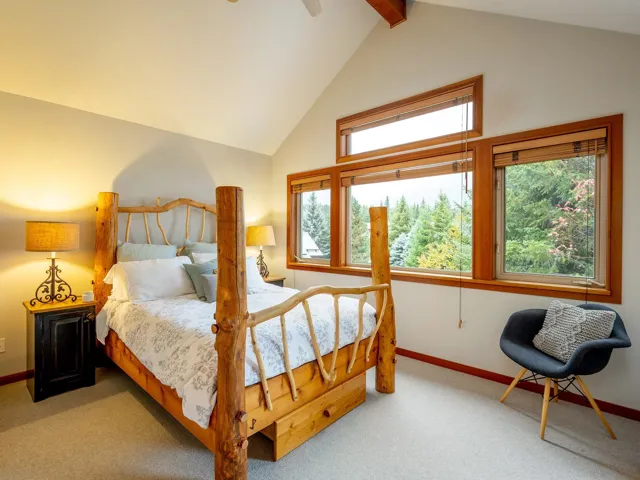 Bedroom featuring carpet floors, beam ceiling, ceiling fan, and high vaulted ceiling