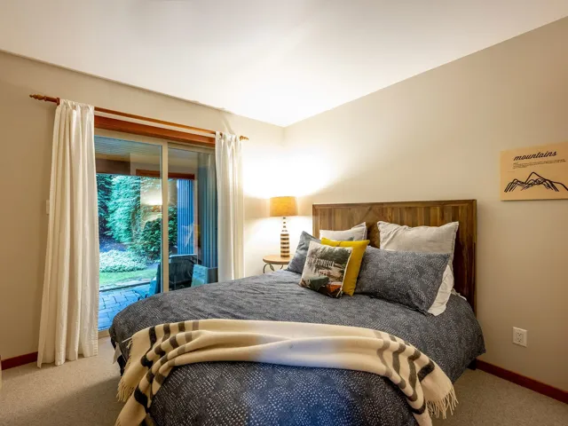 Carpeted bedroom featuring access to outside and baseboards