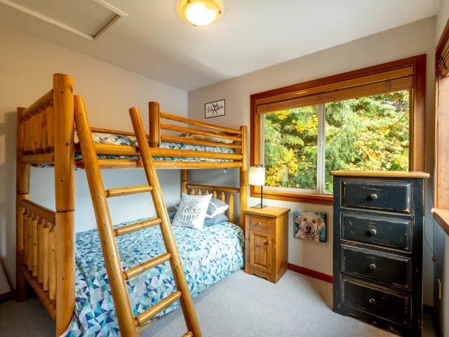Bedroom with light colored carpet and baseboards