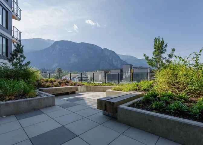 View of property's community with a mountain view and a patio area
