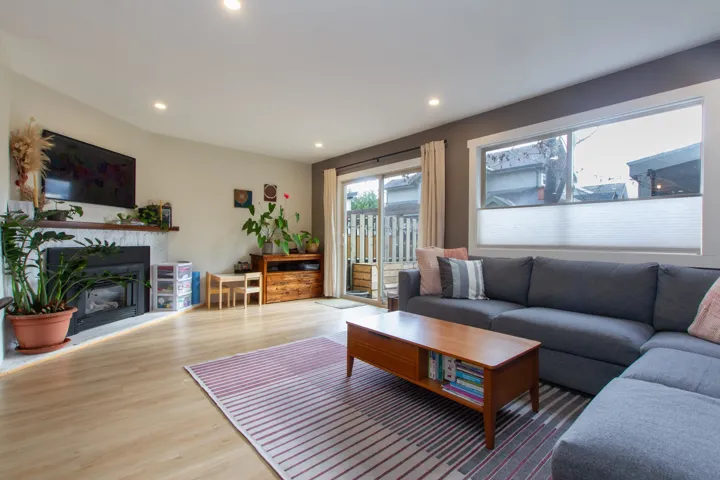 Living area featuring a fireplace, wood finished floors, and recessed lighting