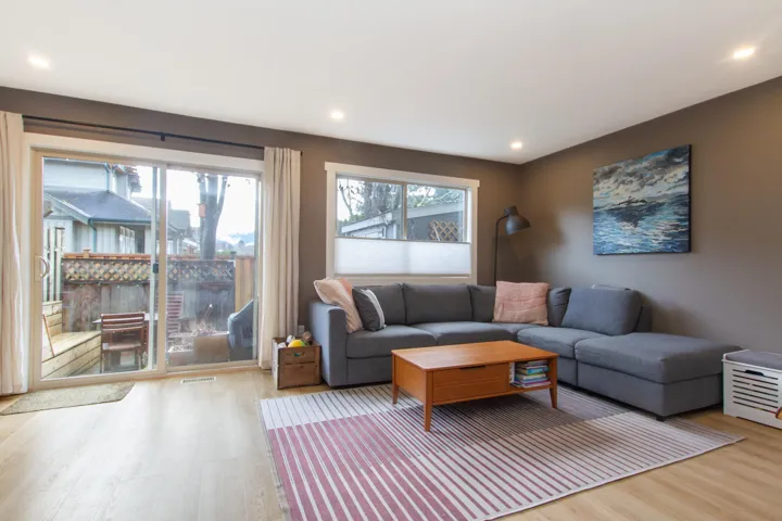 Living area with wood finished floors and recessed lighting