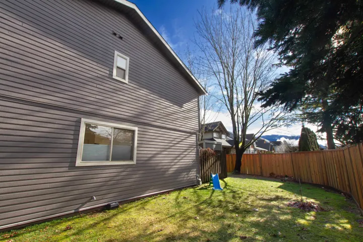 View of home's exterior with a fenced backyard and a yard