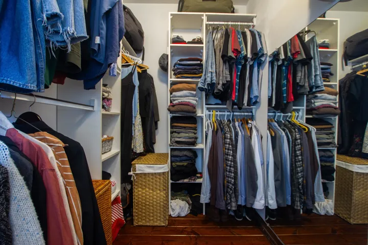 Walk in closet featuring dark wood-style flooring