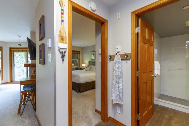 Hall with carpet flooring and baseboards