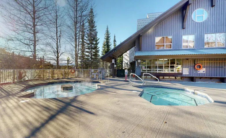 Community pool with a hot tub and a patio