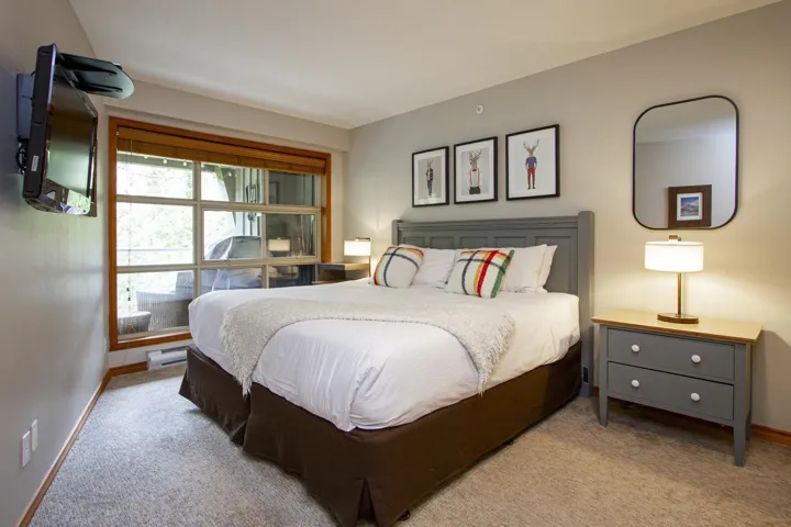 Bedroom with baseboards and light colored carpet