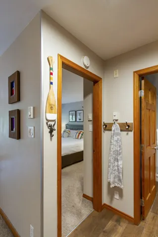 Hallway featuring wood finished floors and baseboards