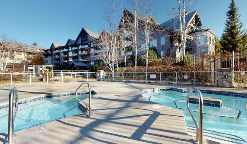 View of swimming pool featuring a hot tub and a pool