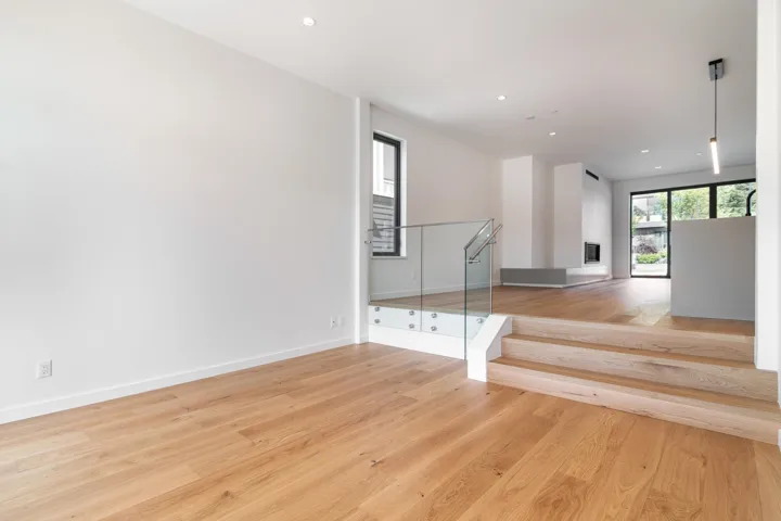 Interior space with baseboards, recessed lighting, wood finished floors, and visible vents