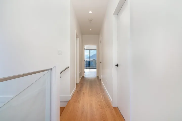 Corridor featuring recessed lighting, light wood-style flooring, and baseboards