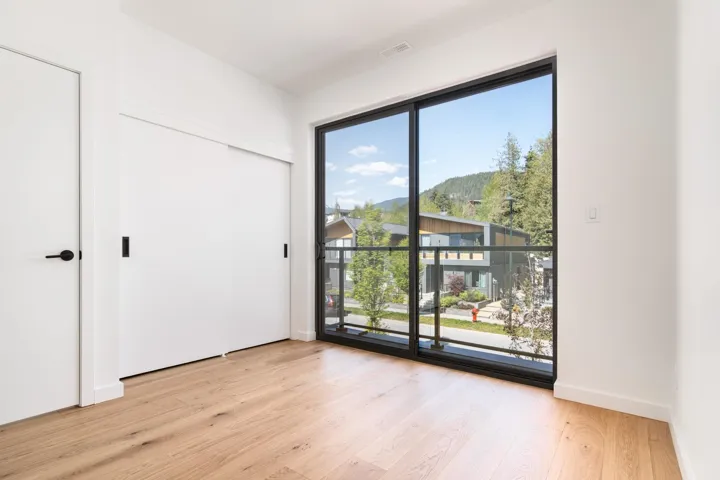 Unfurnished bedroom featuring baseboards, visible vents, access to exterior, and light wood finished floors